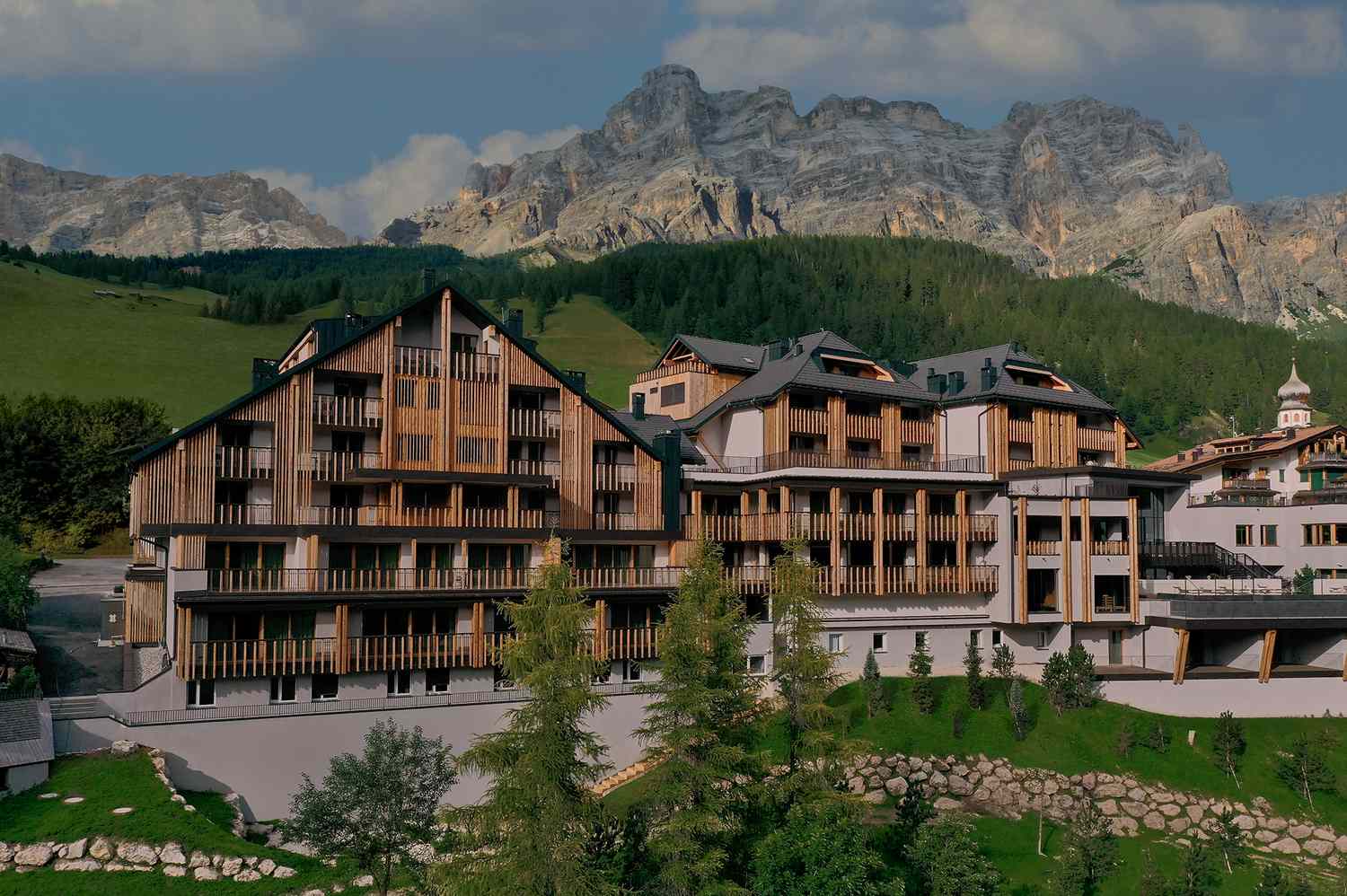 Aman Rosa Alpina in the Dolomites with alpine views, elegant chalet design, and serene luxury setting