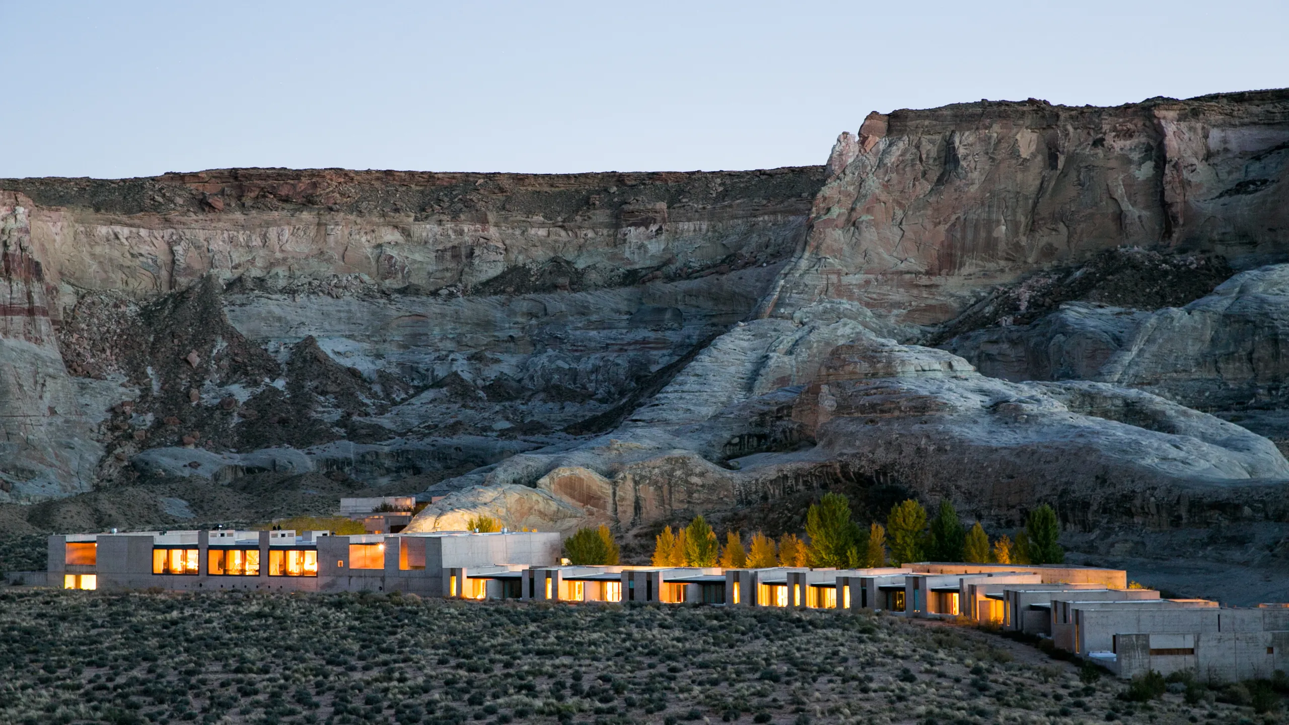 Aerial view of Amangiri in the Utah desert, featuring minimalist architecture blending seamlessly with sandstone cliffs and vast arid landscapes