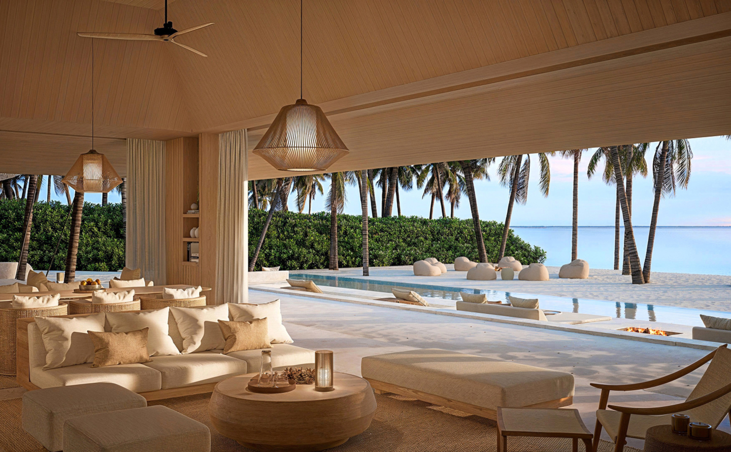 Aerial view of Aman Maldives private atoll resort surrounded by turquoise waters in the Indian Ocean