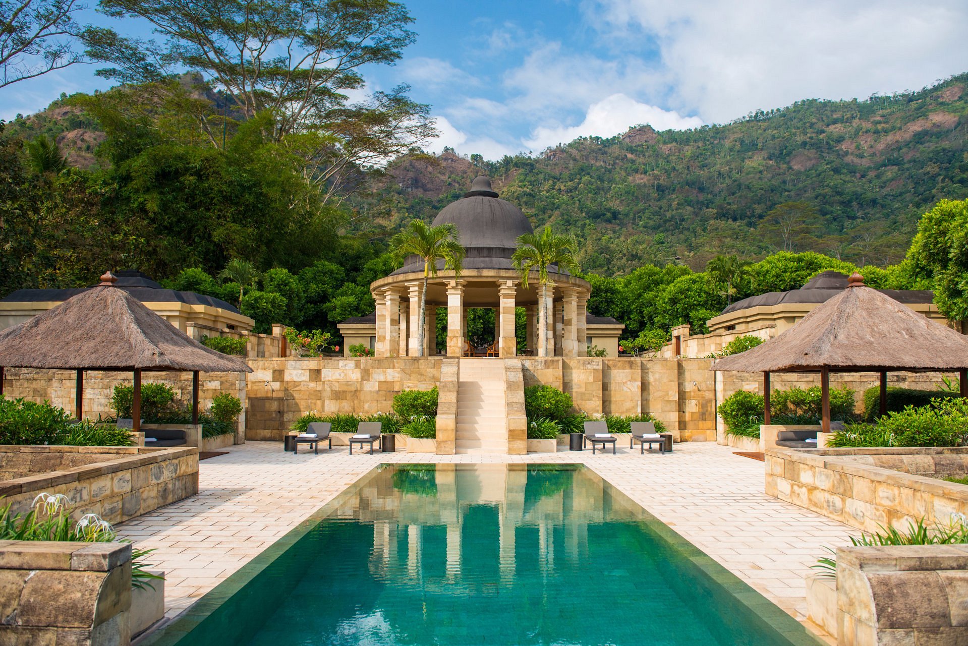 Amanjiwo resort in Central Java, Indonesia with its iconic domed architecture overlooking lush greenery and the nearby Borobudur Temple at sunrise
