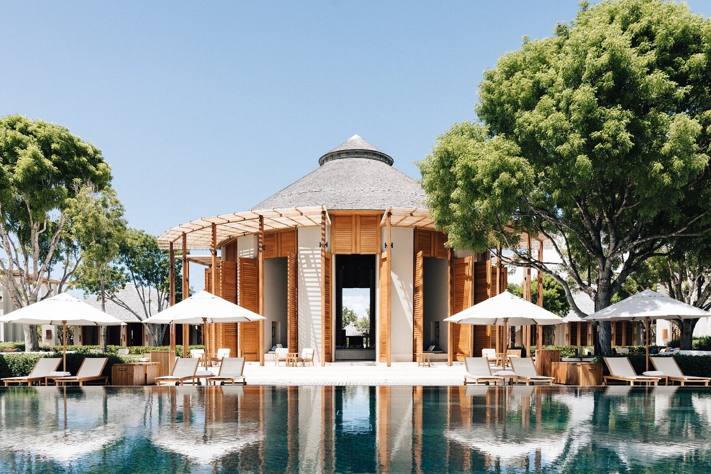 Amanyara resort in Turks and Caicos with sleek modern villas, tranquil reflecting pools, and lush tropical greenery overlooking the Caribbean Sea